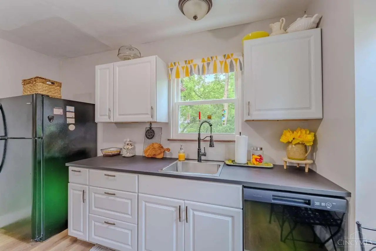 Kitchen with white cabinets and dark countertops
