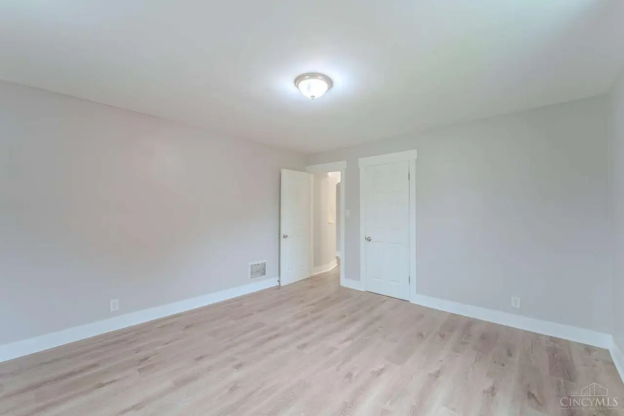 Vacant unit bedroom with updated flooring